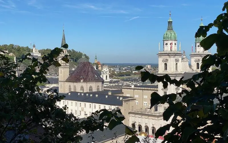 Hohensalzburg Fortress in Austria overlooks Salzburg with towers and domes below.