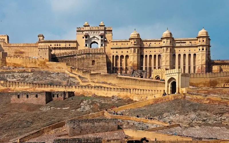 Amer Fort in India stretching across a hillside with golden walls.
