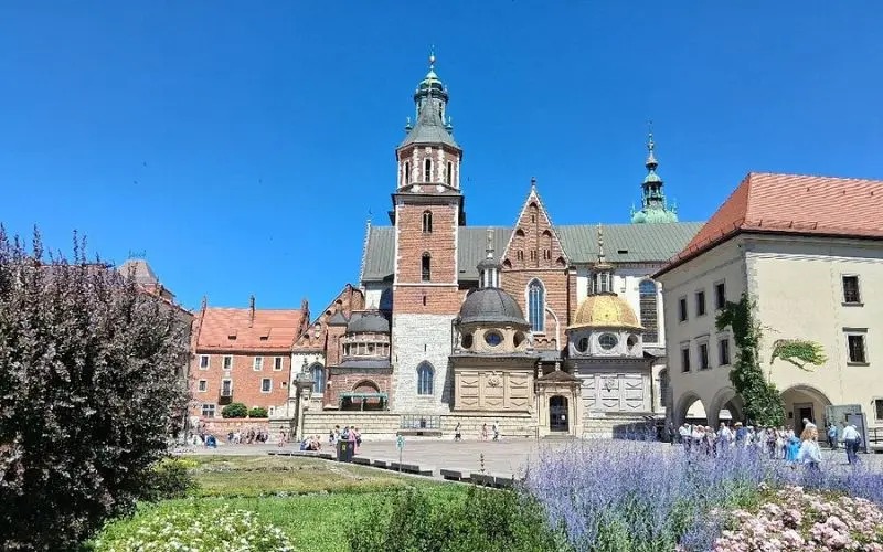 Wawel Castle in Poland with towers and domes on a sunny day.