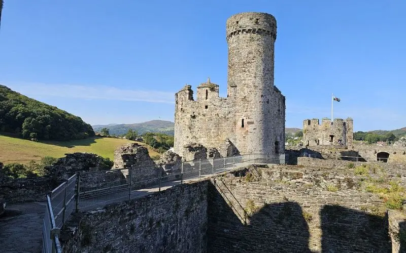 Conwy Castle in Wales with stone towers and surrounding countryside.