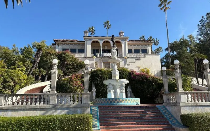 Hearst Castle in California with a grand staircase and fountain leading to the entrance.