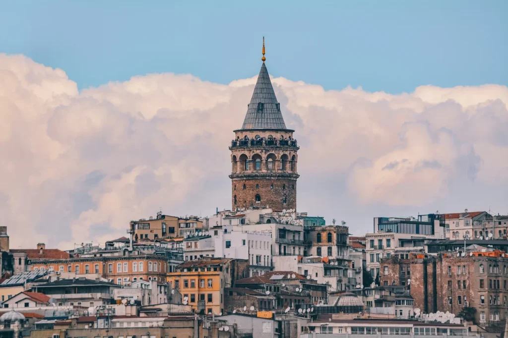 A distant view of the cylindrical stone Galata Tower with its conical roof