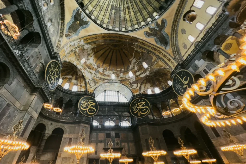 Low angle view of the massive upper dome and arched windows inside Hagia Sophia