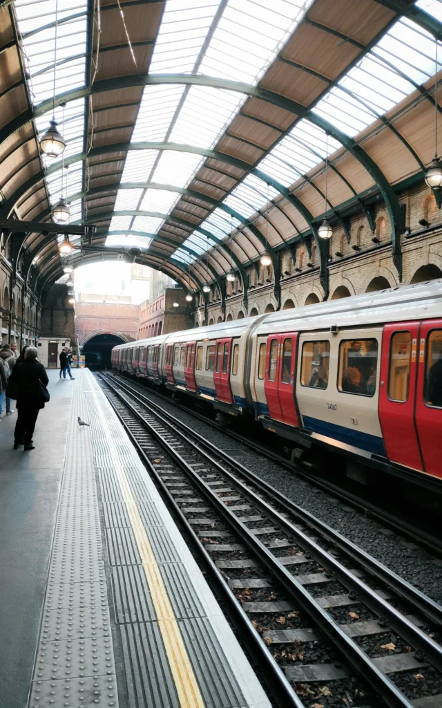 London Underground train stopped at the covered platform of Notting Hill Gate station