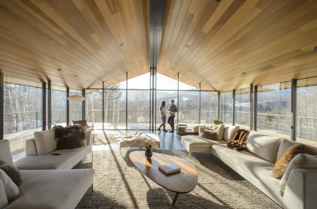 Over-sized living room with glass walls and wraparound decks
