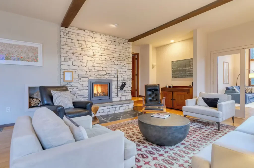 A living room centered around a warm, inviting fireplace