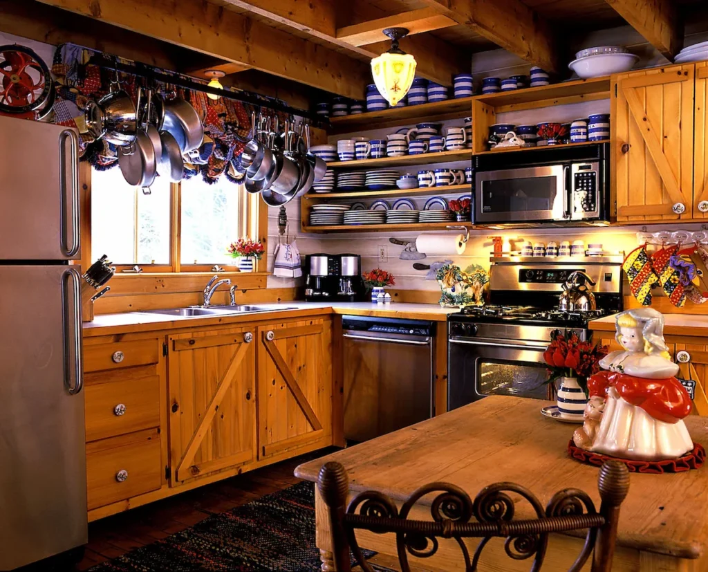 Cozy cabin kitchen with wood cabinets, hanging pots, and blue-and-white dishes