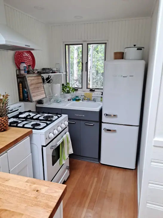 Kitchenette with new gas stove and refrigerator. Includes many cooking amenities
