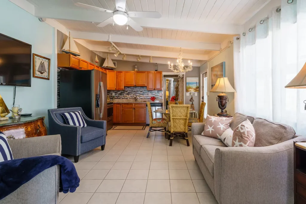 Open-concept beach house living room and kitchen with a tile floor