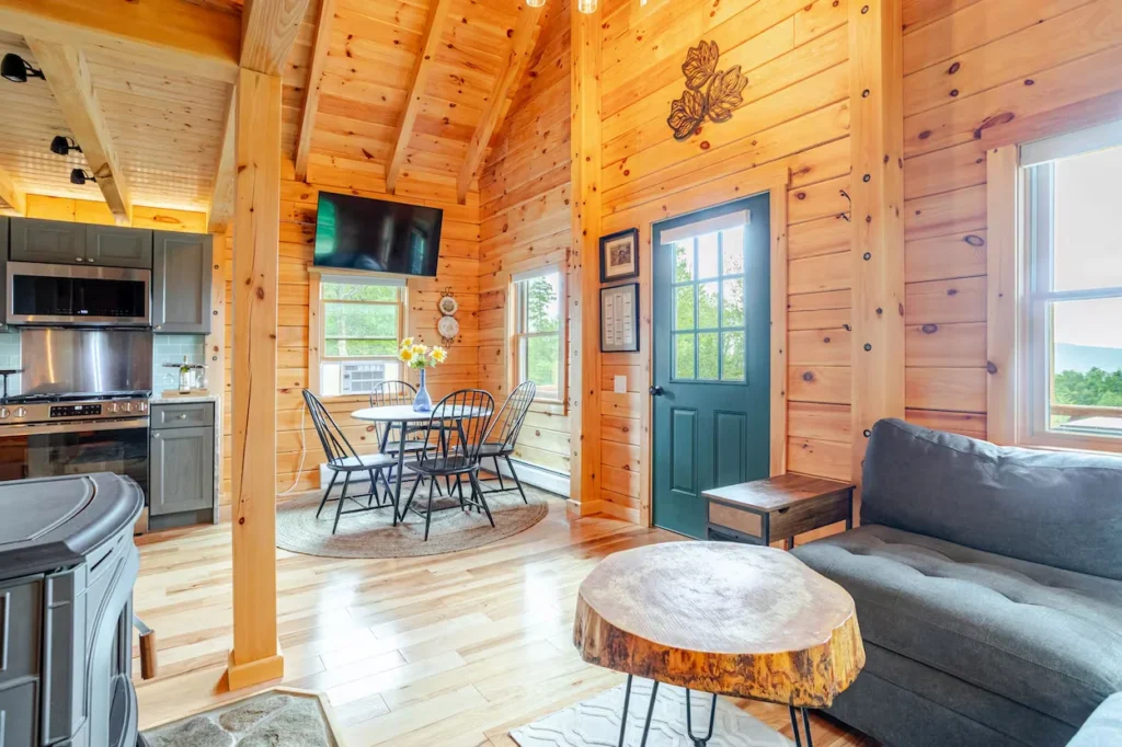 Log cabin interior with a kitchen, dining table, and living room
