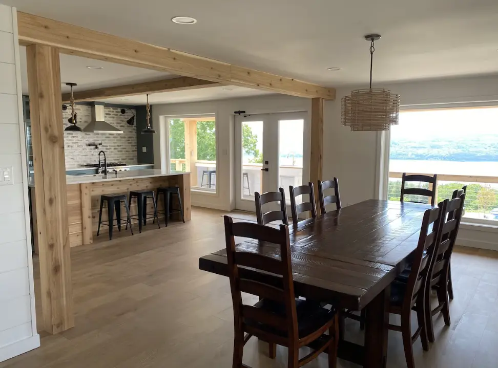 Open concept dining/kitchen with deck doors to grill