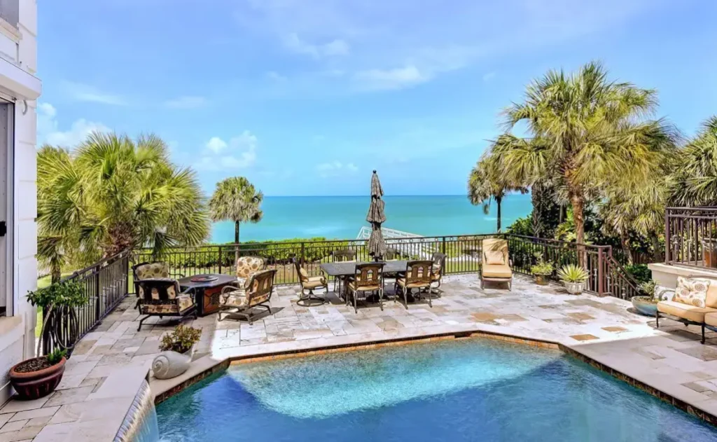 Outdoor dining with swimming pool and ocean view