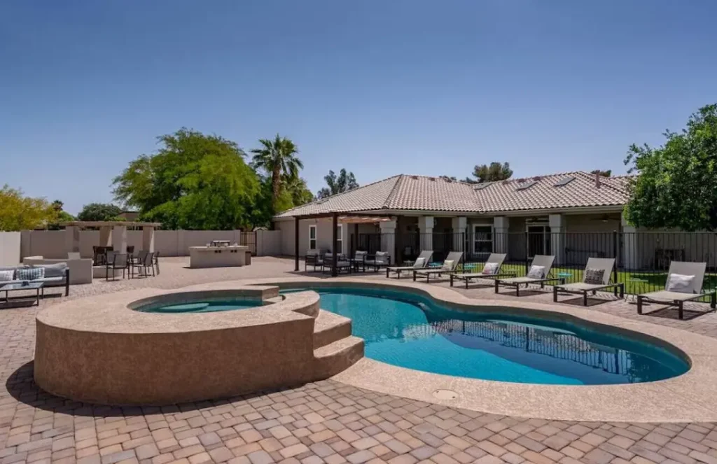 Resort Style heated pool, hot tub, and plenty of loungers and seating