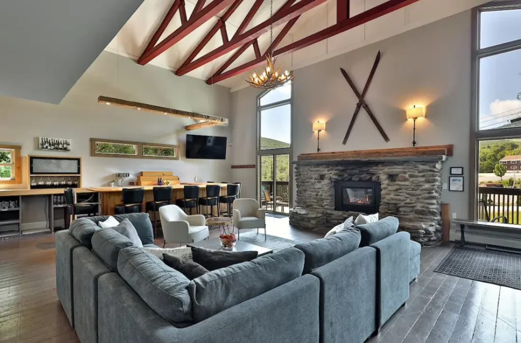 The great room features your own private bar, gas fireplace, and cozy seating