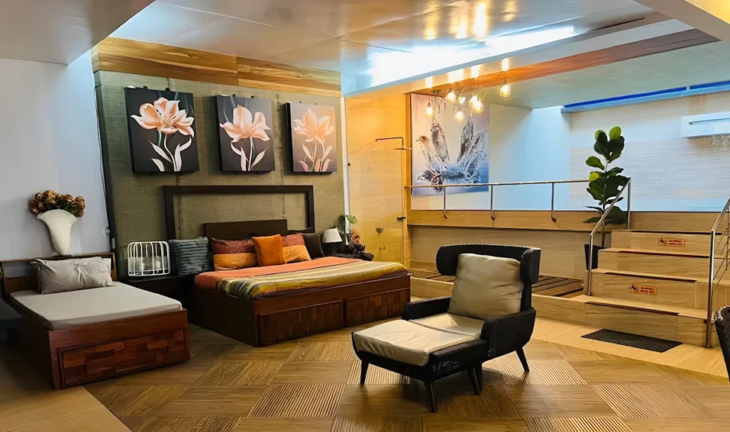 Luxury basement bedroom suite with an elevated indoor swimming pool and wooden floors