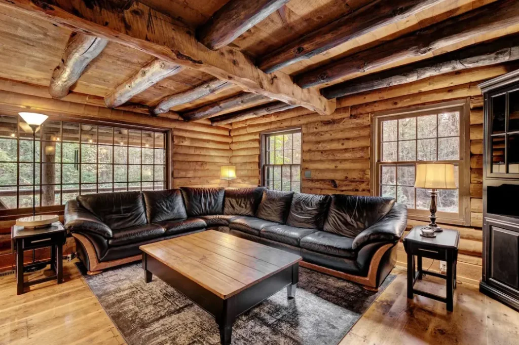 Gorgeous log cabin with exposed log trusswork and original pine floors