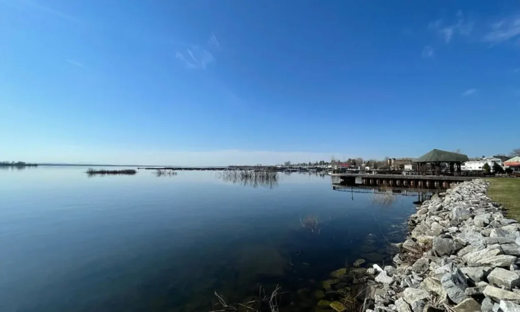 View of Lake Champlain with clear blue skies and calm water.