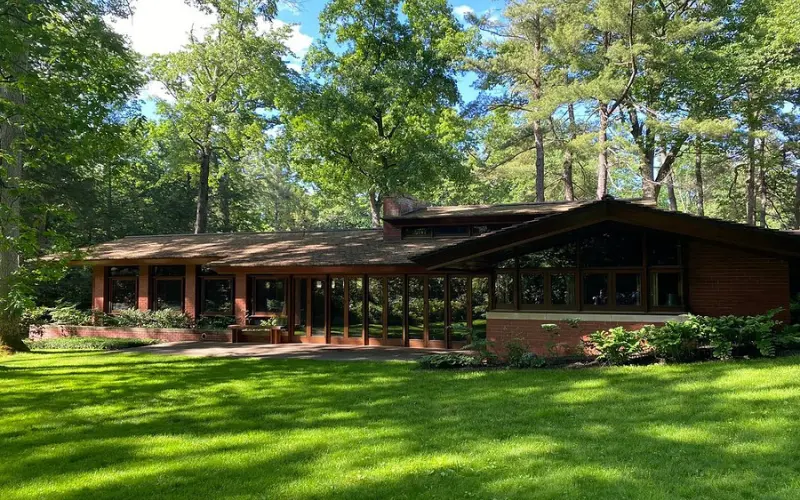The Zimmerman House is a modern-style home surrounded by trees and green lawn.