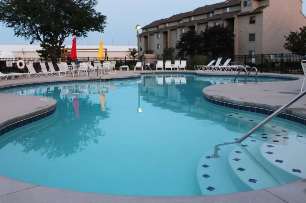 Near lake house with a swimming pool