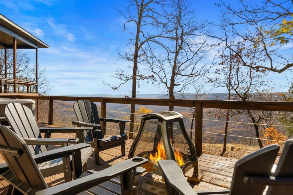 Compton Arkansas cabin deck with Adirondack chairs and a lit fire pit