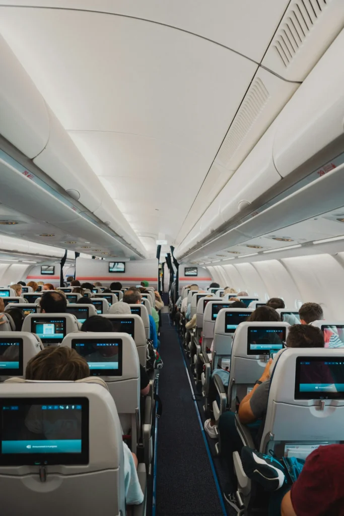Economy class cabin of an Air Transat Airbus looking down the central aisle