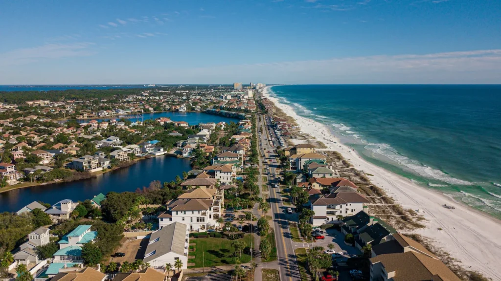 An aerial view of Scenic Highway 98 running between beach houses and the Gulf of Mexico in Destin, Florida