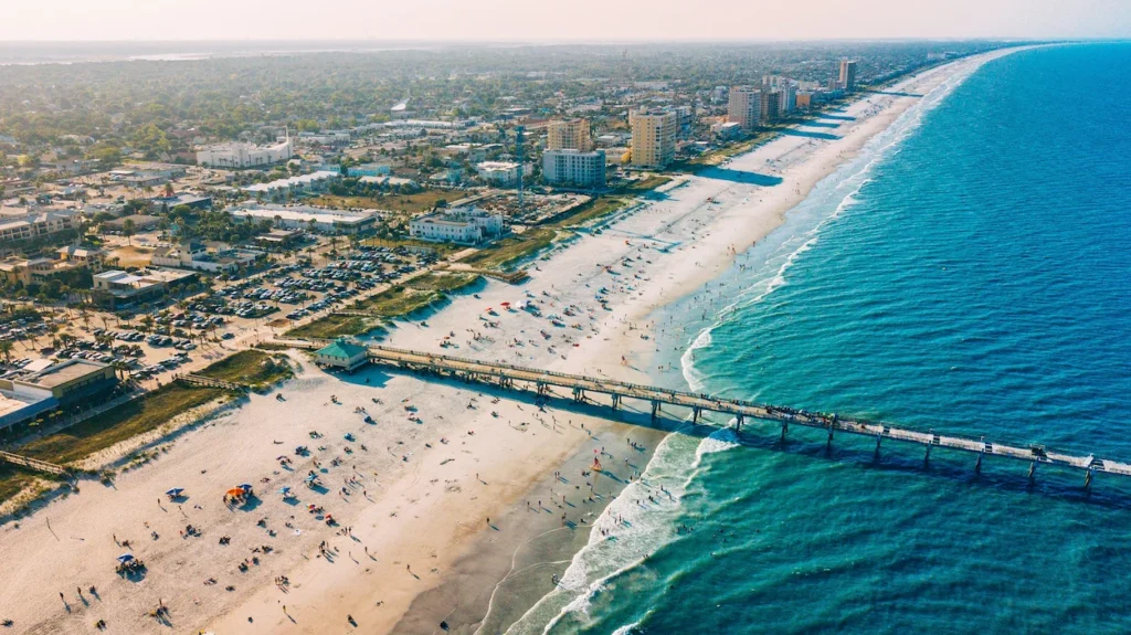 An aerial view of Jacksonville Beach Pier stretching into the ocean in Florida