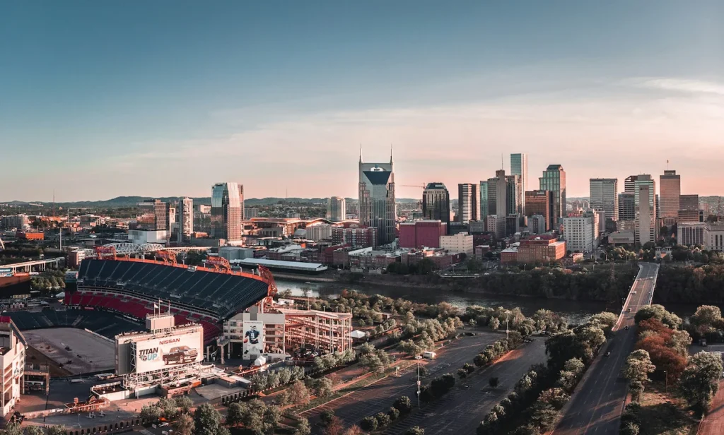 The Nashville city skyline and Nissan Stadium at sunset