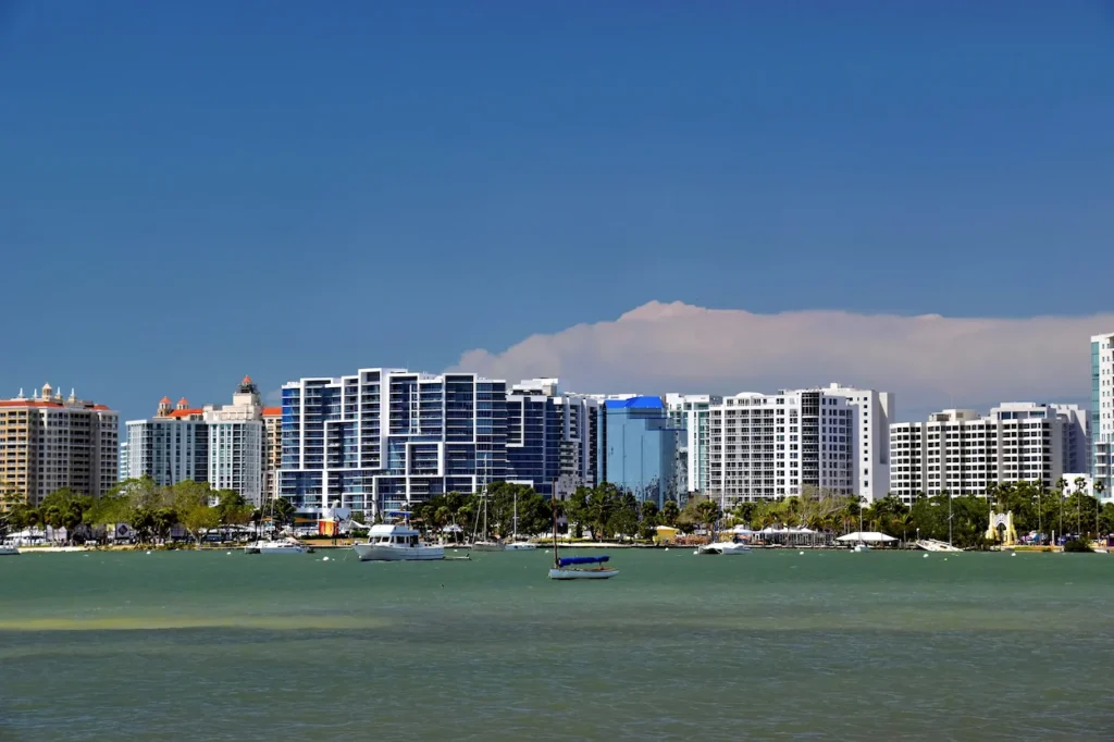 Sarasota skyline and high-rise buildings looking across the waterfront with scattered boats in Florida