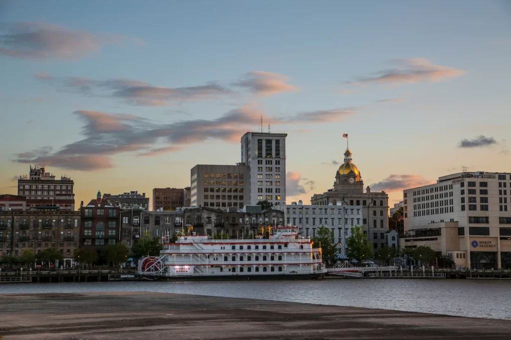 Georgia Queen riverboat docked on the Savannah riverfront near the gold-domed City Hall