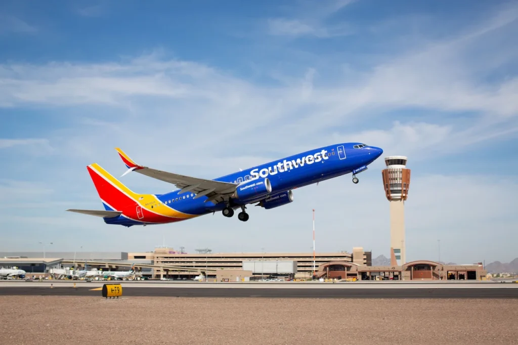 Southwest Airlines Boeing 737 airplane taking off near a control tower