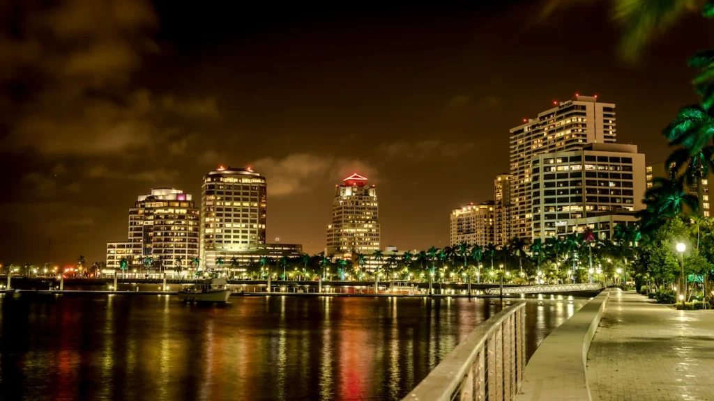 The West Palm Beach skyline illuminated at night across the water