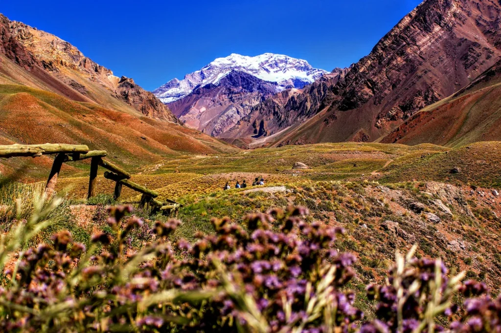 Snow-capped peak of Mount Aconcagua rising behind a mountain valley