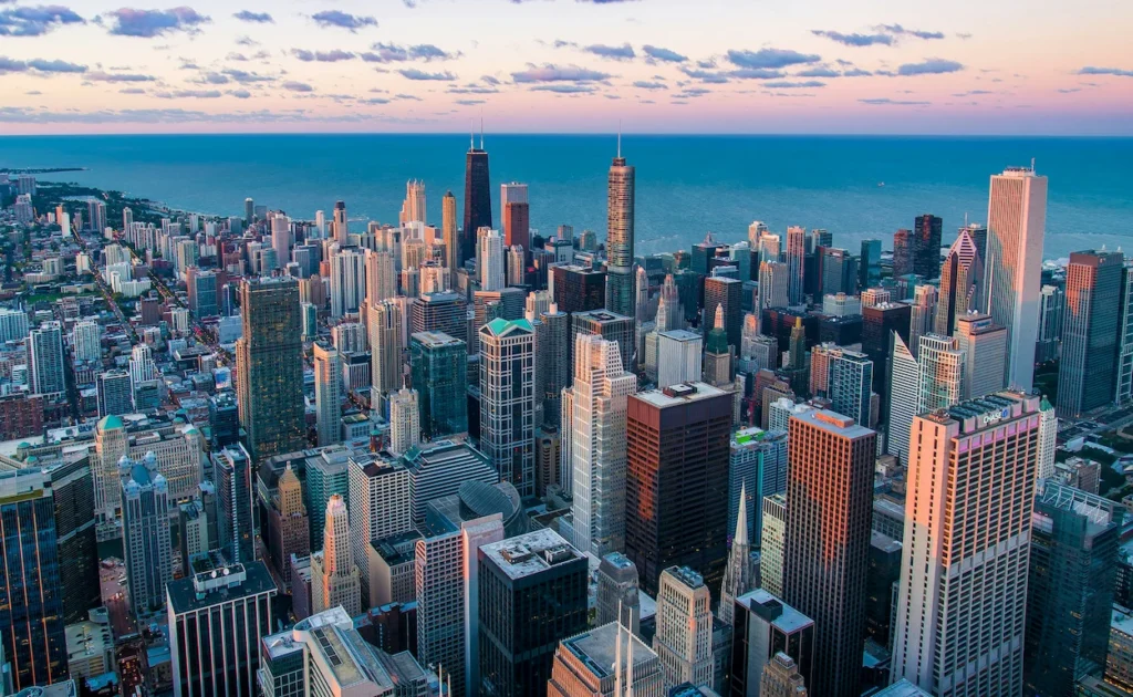 Aerial view of the downtown Chicago skyline and Lake Michigan at sunset