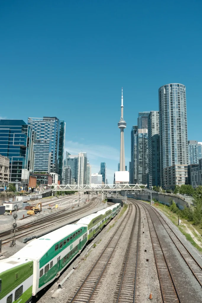 GO Train on tracks leading toward the CN Tower in Toronto