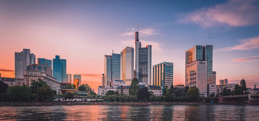 Frankfurt city skyline over the Main River during a pink sunset