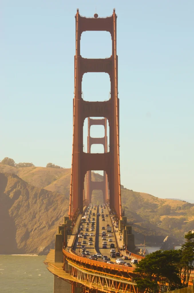 Golden Gate Bridge south tower in San Francisco with heavy car traffic driving across the suspension span