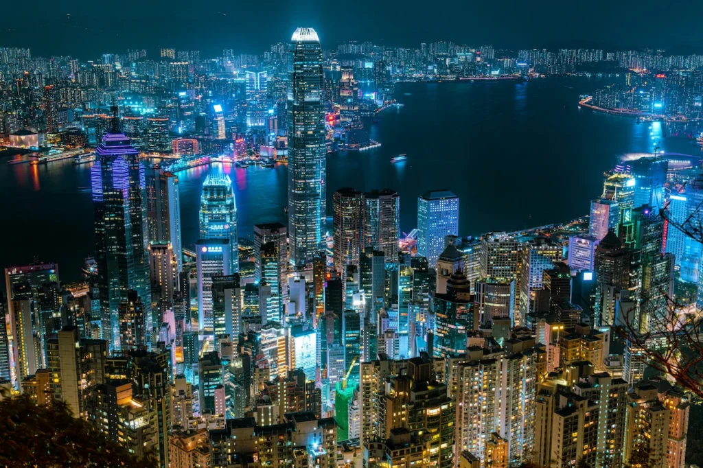 High-angle night view of illuminated Hong Kong skyscrapers and Victoria Harbour