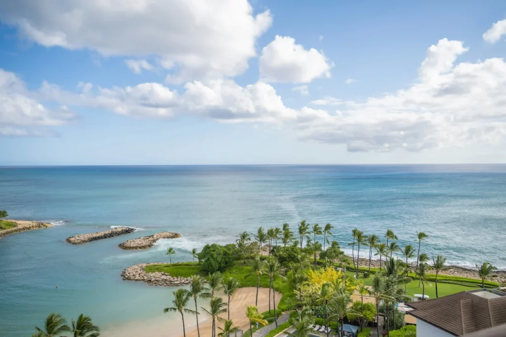 Ocean view overlooking a calm beach lagoon and palm trees at Ko Olina on Oahu