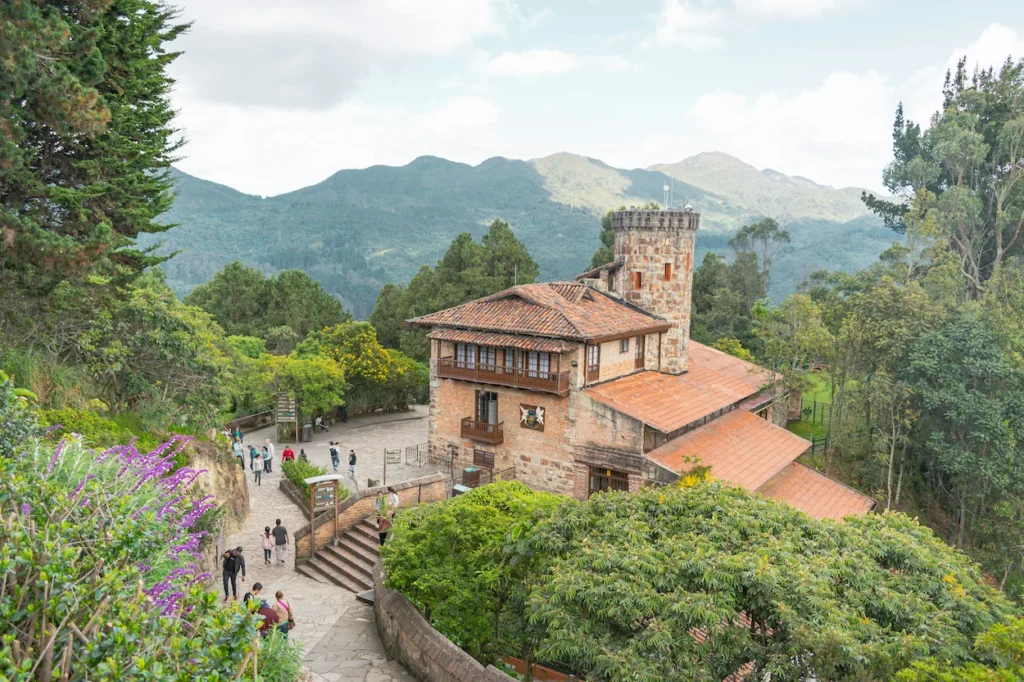 Stone building with a watchtower surrounded by trees on Monserrate mountain
