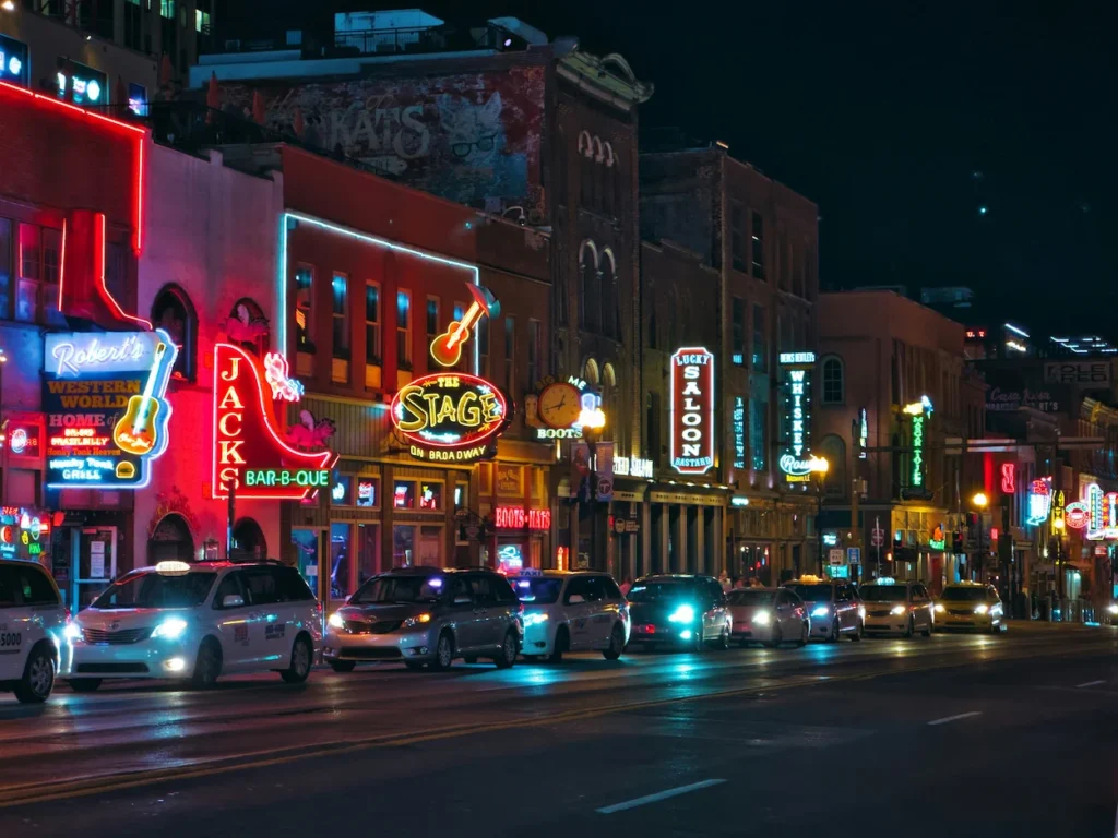 Bright neon signs illuminating Lower Broadway at night in Nashville