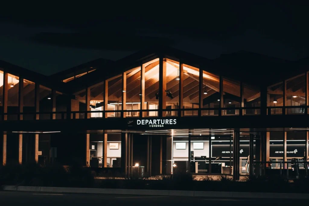 The glowing departures terminal building of Nelson Airport at night