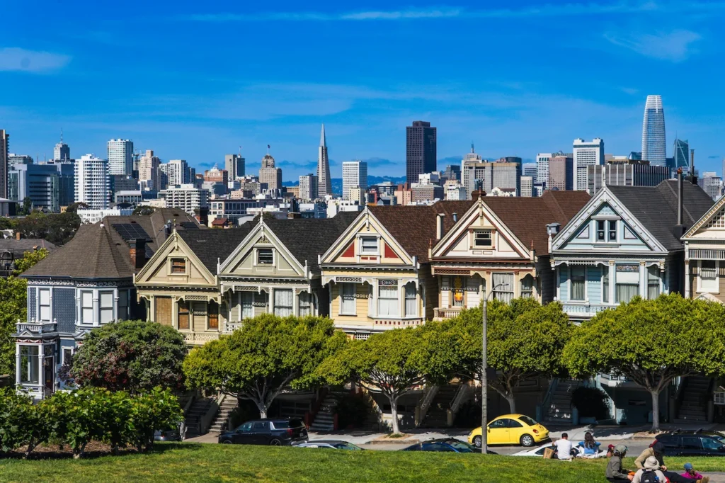 Seven colorful Painted Ladies Victorian houses at Alamo Square with the modern San Francisco skyline background