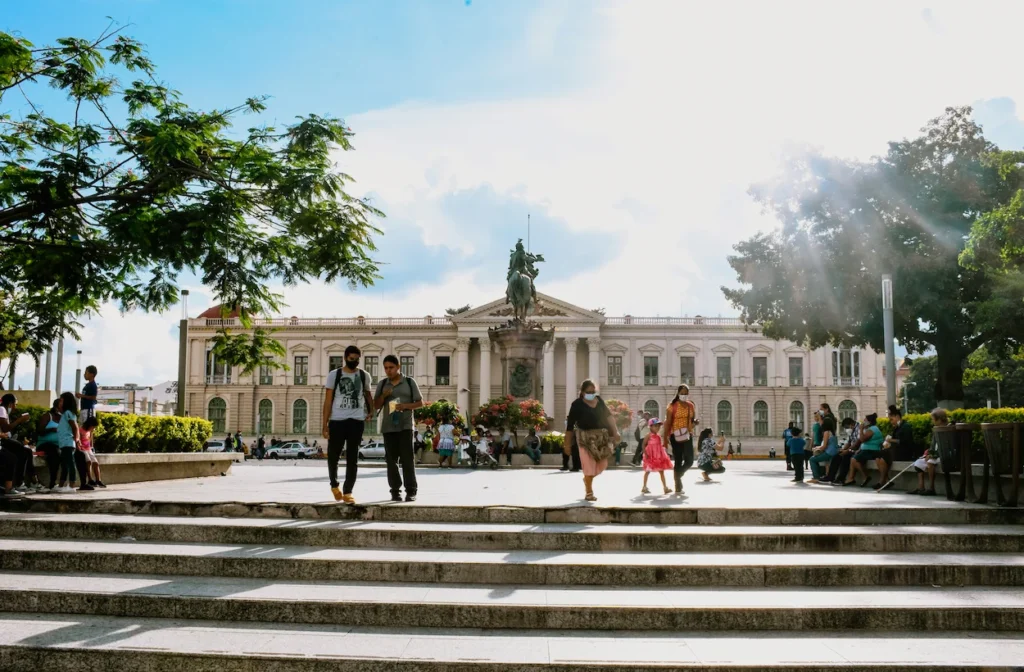 People walking in San Salvador's Plaza Barrios in front of the National Palace