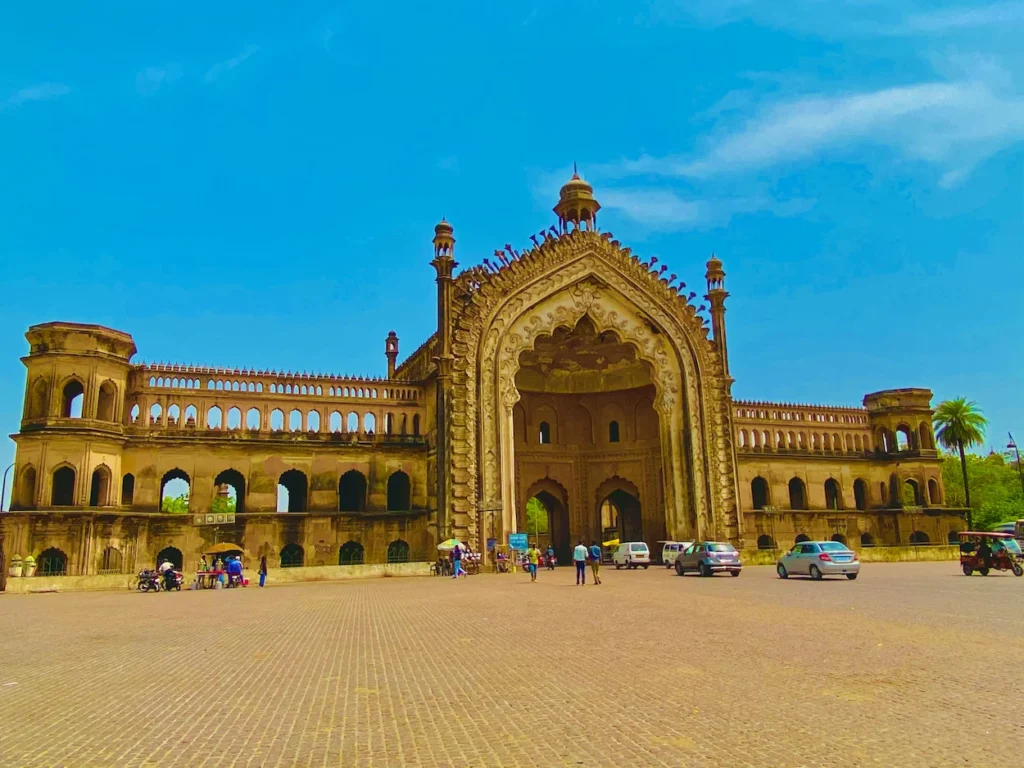 Ornate stone archway of Rumi Darwaza monument under bright blue sky
