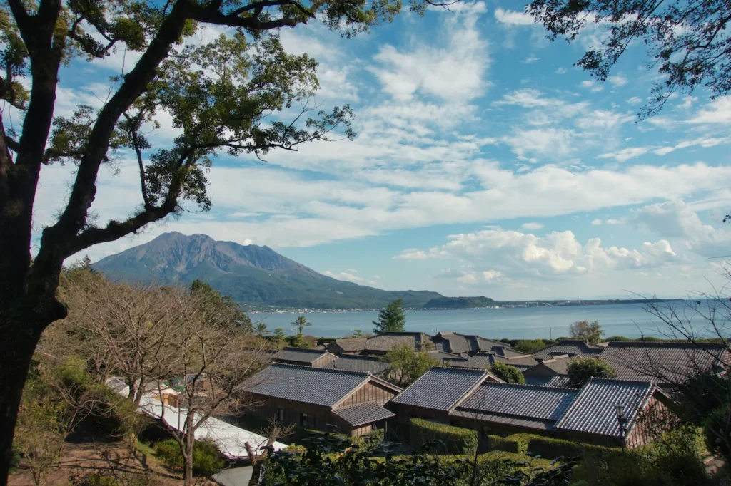 Traditional houses in Sengan-en Garden with Mount Sakurajima and the bay in the background