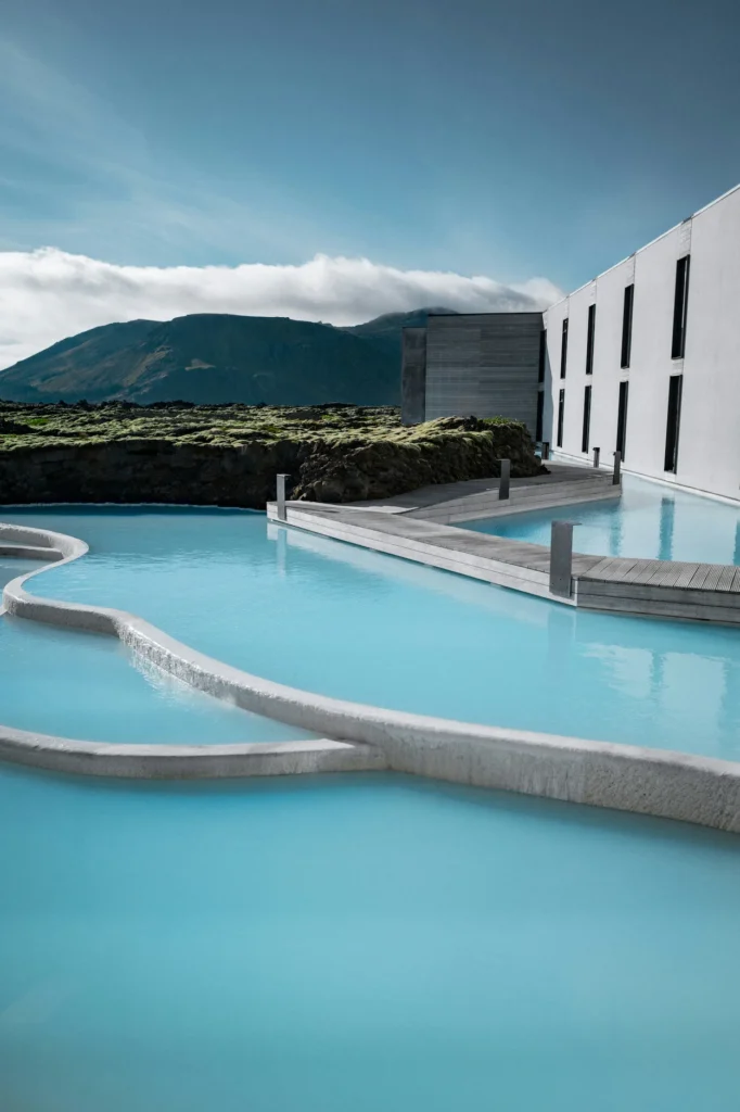 Milky blue geothermal pools wrapping around the modern white facade of The Retreat at Blue Lagoon in Iceland
