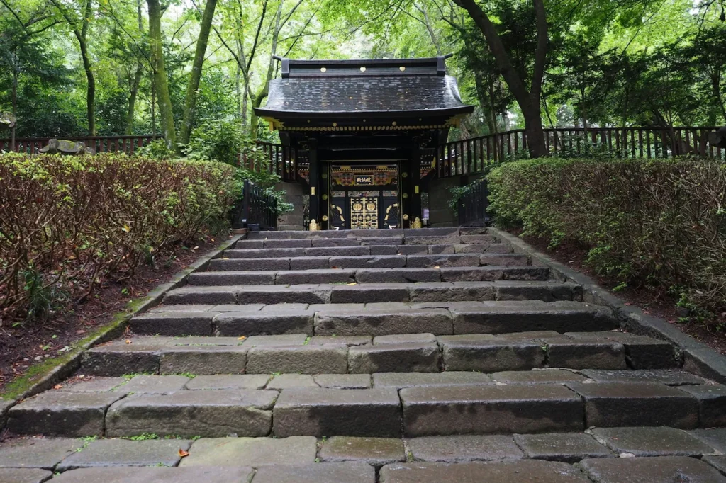Stone stairs leading up to the black and gold gate of Zuihoden Mausoleum in Sendai