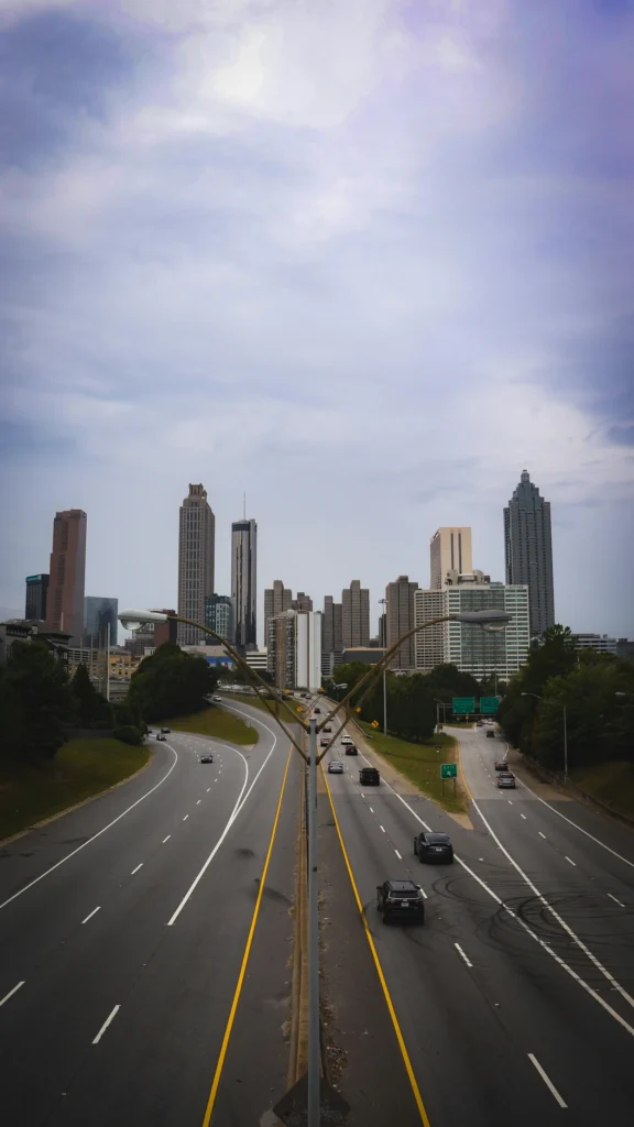 Atlanta skyline seen from Freedom Parkway with cars driving on the highway below