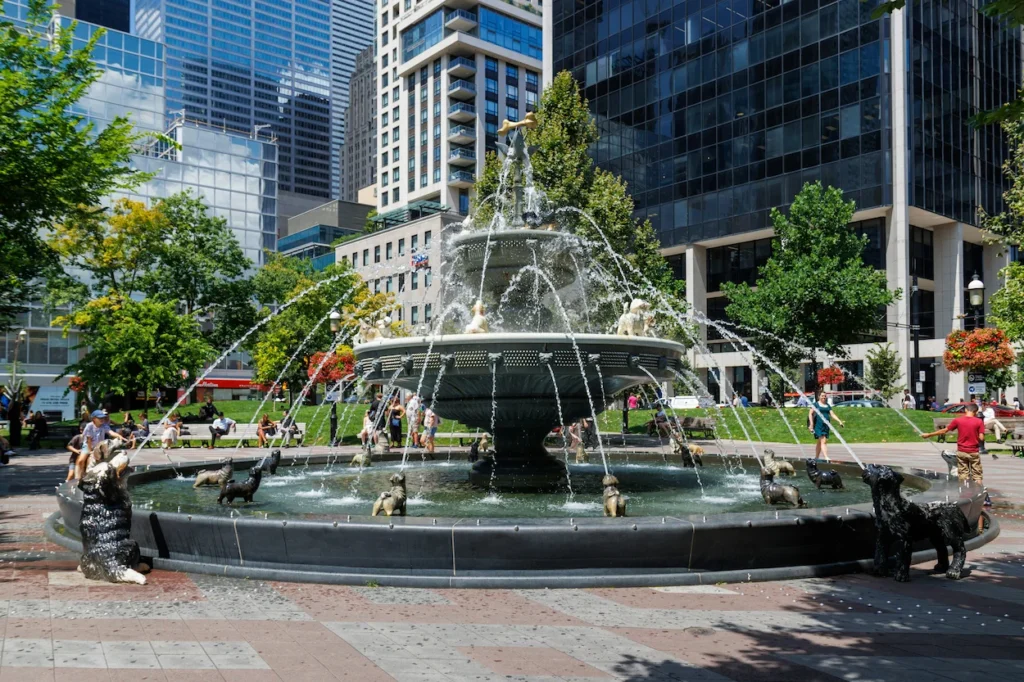 The multi-tiered dog fountain at Berczy Park surrounded by skyscrapers